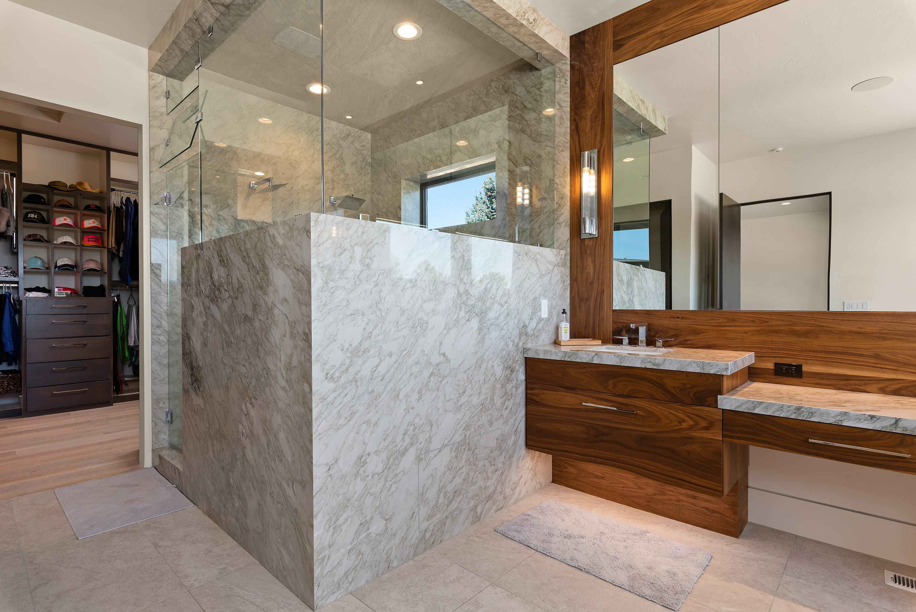 Full marble master bathroom with floating vanity and shower surround — Superior Stone Boise